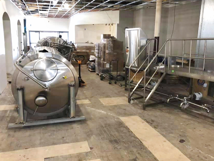 Brewing equipment being installed at Juniper Brewing Company earlier this summer