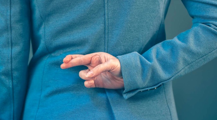 Woman with fingers crossed behind back. Caption: 66% of HR Professionals have reported having issues with chronic abuse of intermittent leave.